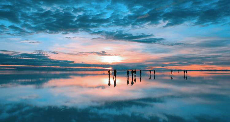 Reflection of a stunning sunset over a salt flat.