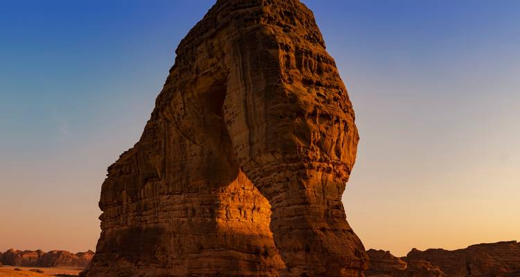 Large sandstone rock formation at sunset.
