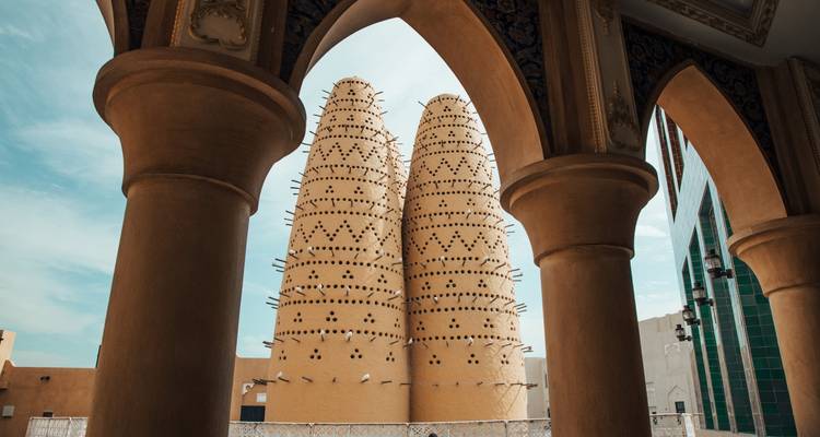 Traditionele bijenkorfvormige structuren omlijst door bogen.