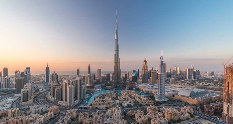 Panoramic view of downtown skyline dominated by a tall skyscraper.
