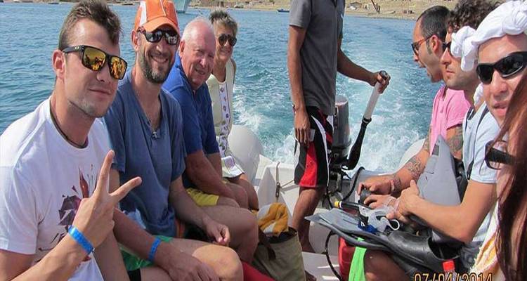 Groupe de personnes assises dans un bateau sur l'eau.