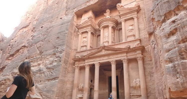 Persona observando la fachada del Tesoro de Petra.