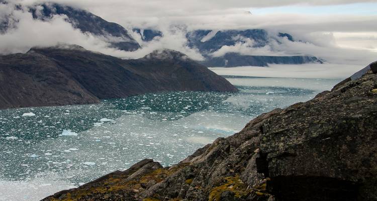 Glacial valley with icebergs in a dramatic landscape.