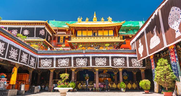 Tibetan temple courtyard with intricate decor.