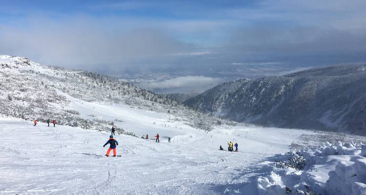Skiers enjoying the snowy mountain slopes.