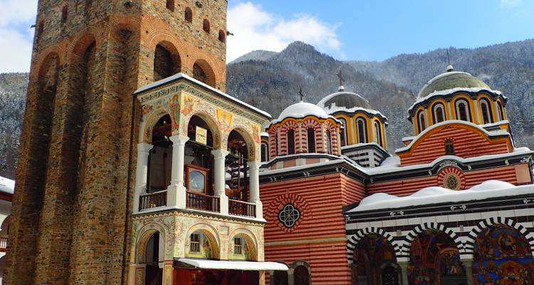 Rila Monastery with snow-covered mountains in the background.