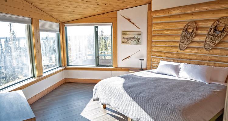 Modernes Zimmer mit großen Fenstern und Holzinterieur.