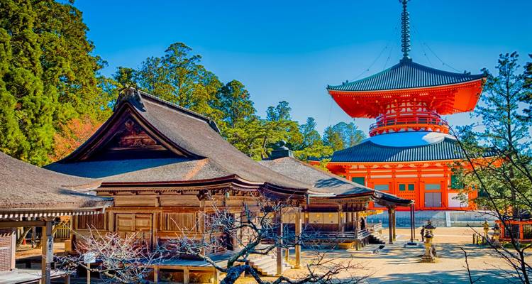 Temple complex with a vibrant red pagoda.