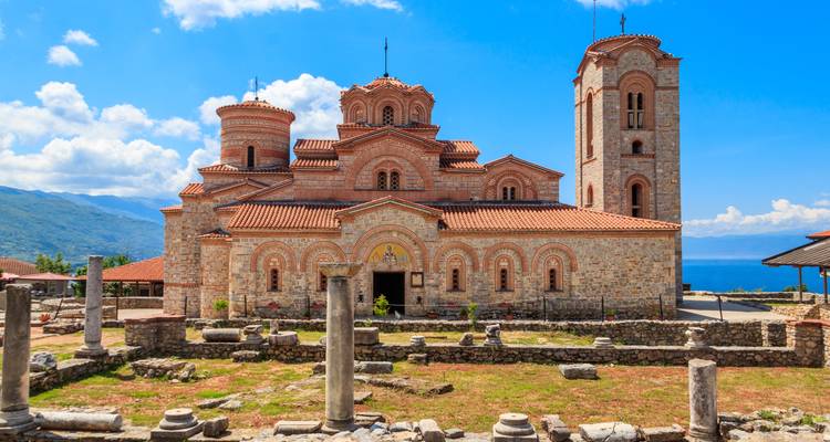 Ancient church with towers overlooking a scenic lake