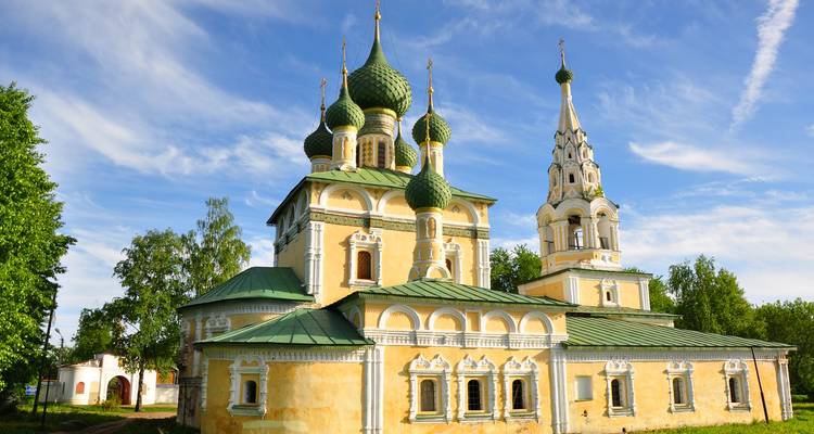 Russian Orthodox church with green onion domes and a bell tower.