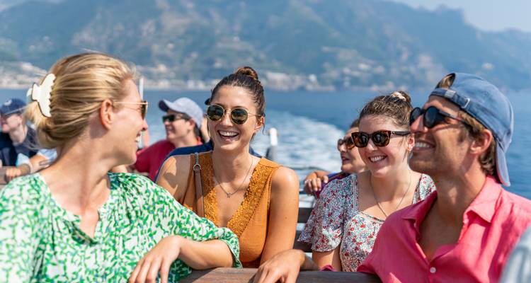 A group of people enjoying a boat ride with scenic views.