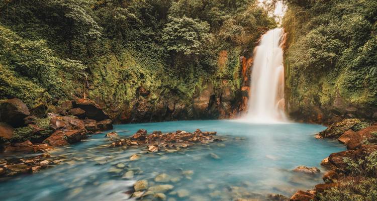 A stunning waterfall surrounded by lush vegetation.