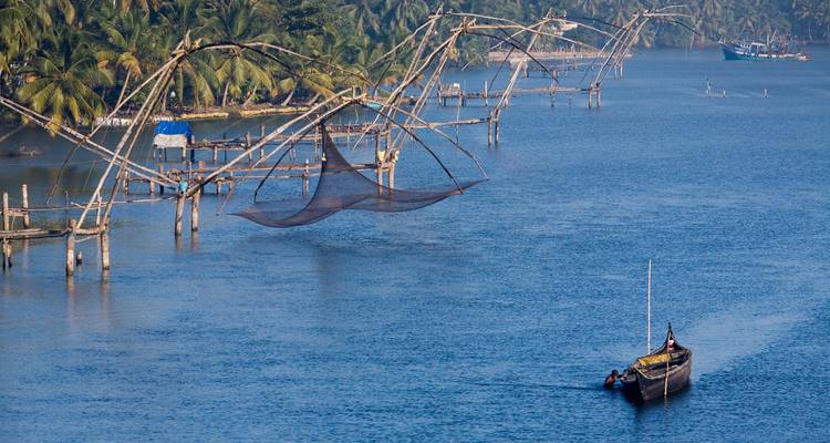Scène de filets de pêche chinois et d'un bateau sur des eaux bleues calmes.