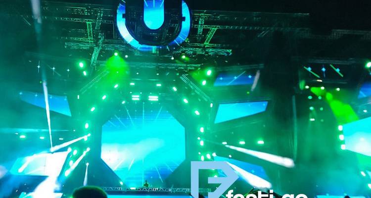 Une scène de concert nocturne avec des néons et un filigrane.