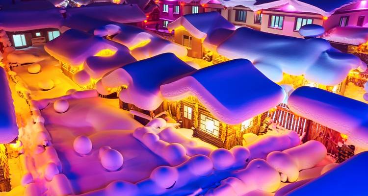 Vibrant winter scene with snow-covered colorful houses.