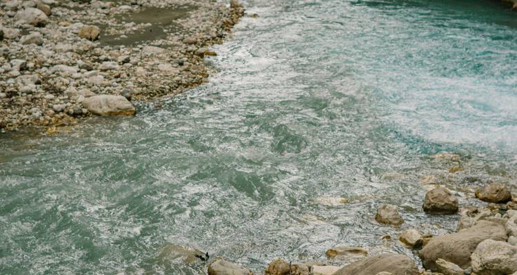 Fließendes Flusswasser mit Felsen entlang des Ufers.