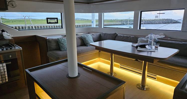 Interior of a yacht with a seating area and table.