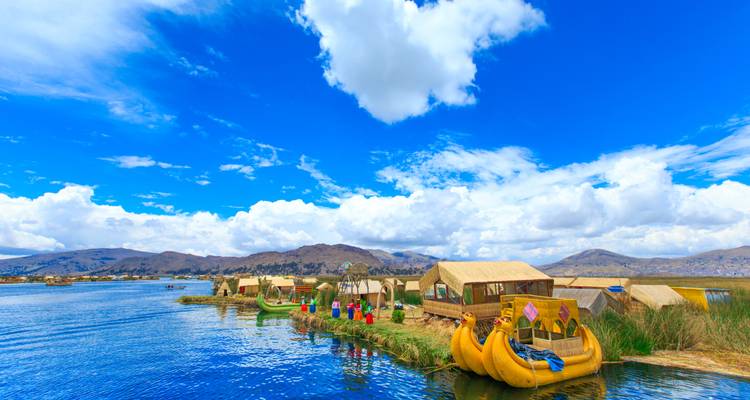 Reed islands with colorful boats on Lake Titicaca.