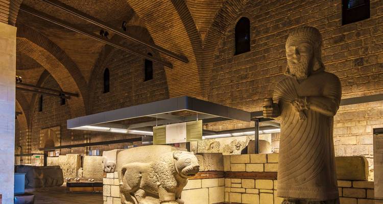 Intérieur d'un musée avec des statues anciennes.