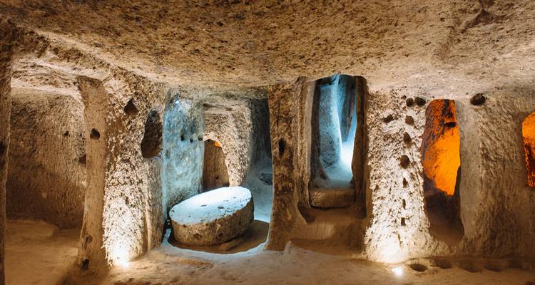 Grotte souterraine avec des murs et des passages illuminés.
