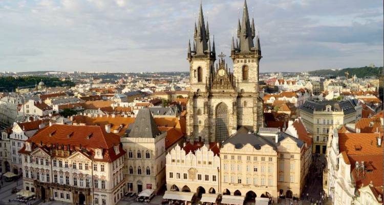 Church of Our Lady before Týn in Prague surrounded by historic buildings.
