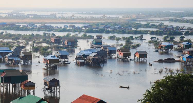 Floating village over a flooded area with boats.