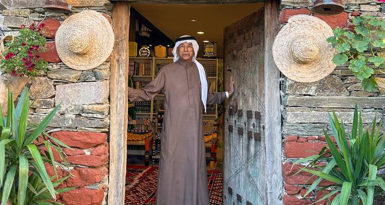Man in traditional clothing standing in a doorway.