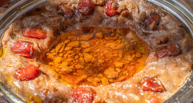 Traditional dish in a pot with vibrant colors.