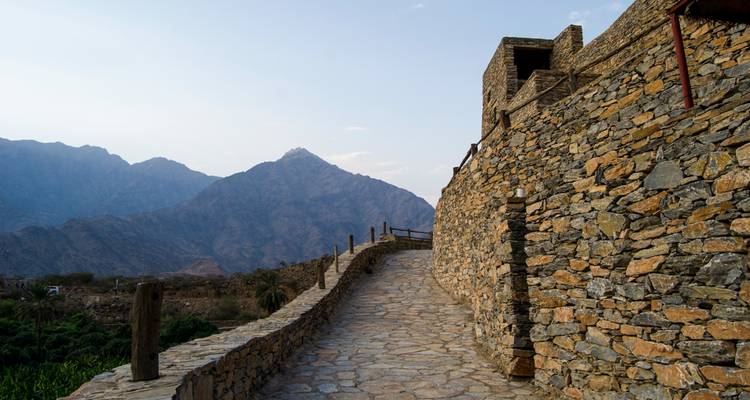 Stone pathway alongside a mountainous landscape.