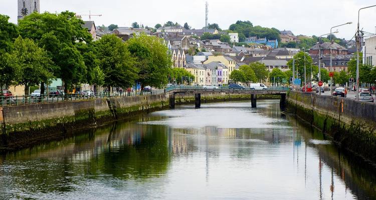 River with a small bridge and colorful buildings