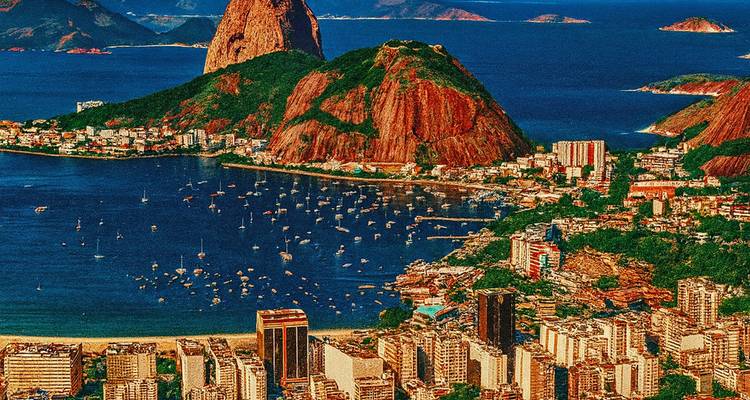 A vibrant aerial view of a city with mountains and ocean.