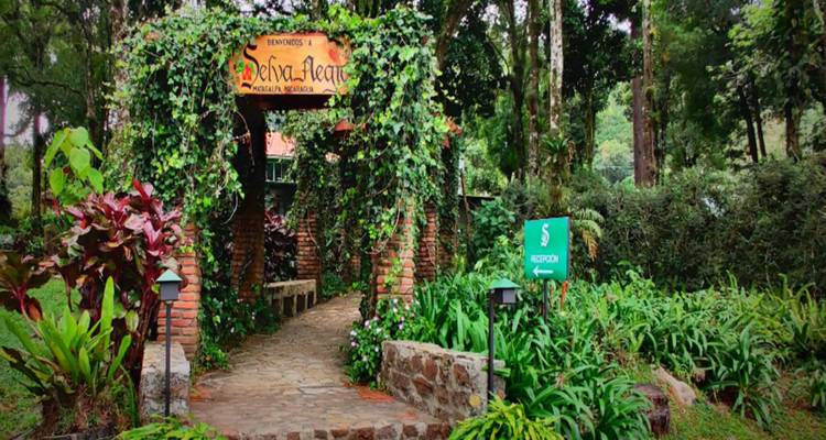 Welcome sign at the entrance of a garden path.