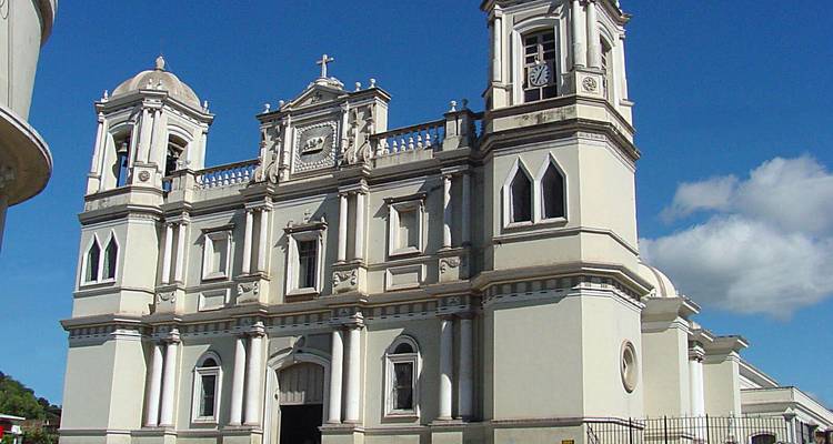 Grand white church under a bright blue sky.