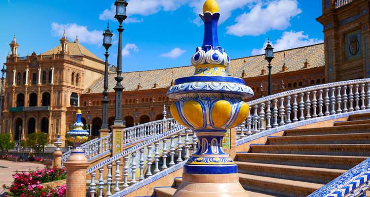 Colorful ceramic balustrades with a historical building in the background.