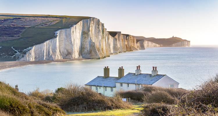 White cliffs with a house on the coastline.