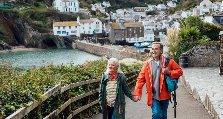 Couple profitant d'une promenade le long de la côte avec des vues charmantes sur le village.