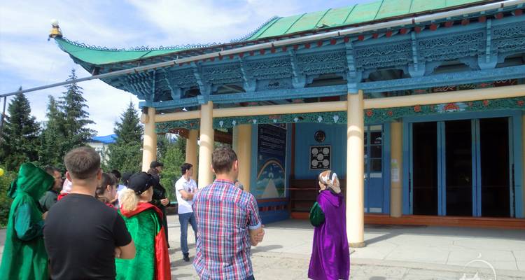 Group of tourists outside a traditional building.