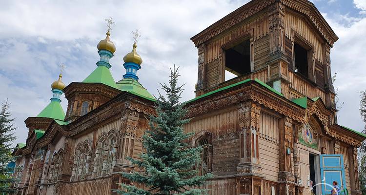 Traditional wooden Orthodox church with blue roofs.