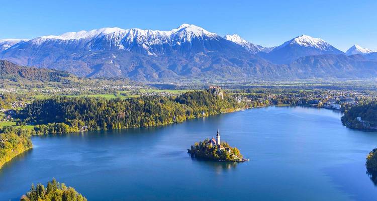 Vista aérea espectacular del lago Bled con su iglesia en la isla situada frente a los Alpes nevados.
