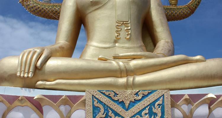 Partial view of a large golden Buddha statue.