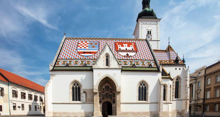 Church with intricate vaulted roof tiles and a central tower.