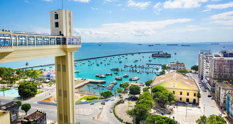 Panoramic view of an urban coastline with harbor, piers, and sea.