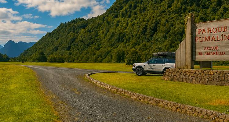 Entrance to Parque Pumalín, sector El Amarillo, with a car parked nearby and lush greenery.