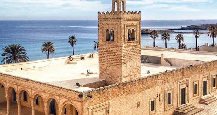 A historic mosque building by the sea.
