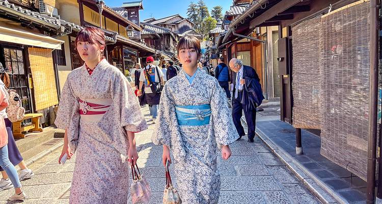People in traditional clothing walking in a Japanese street.