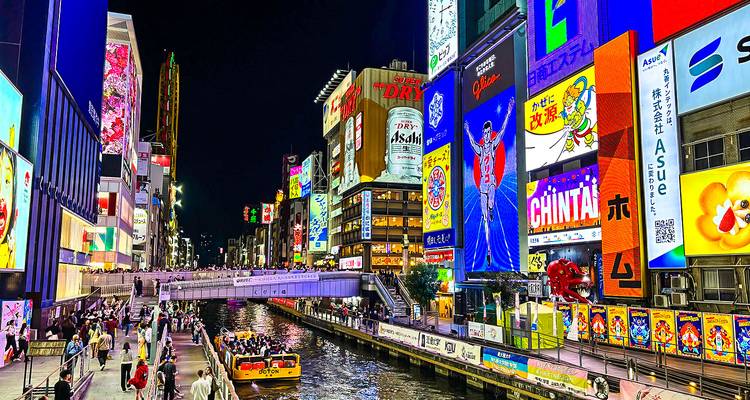 Illuminated cityscape with neon lights at night.