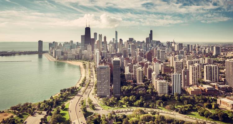 Aerial view of a city skyline by a large body of water.