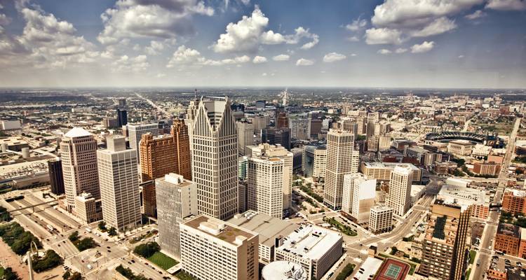 City skyline under cloudy skies viewed from above.
