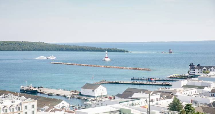 Coastal area with waterfront buildings and a lighthouse.