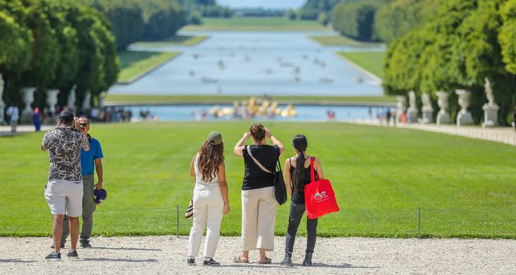 Tourists viewing the gardens of Versailles.